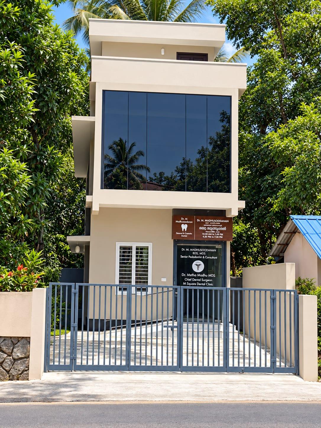 M Square Dental Clinic building with grey gate and brown signboard, Vallikeezhu